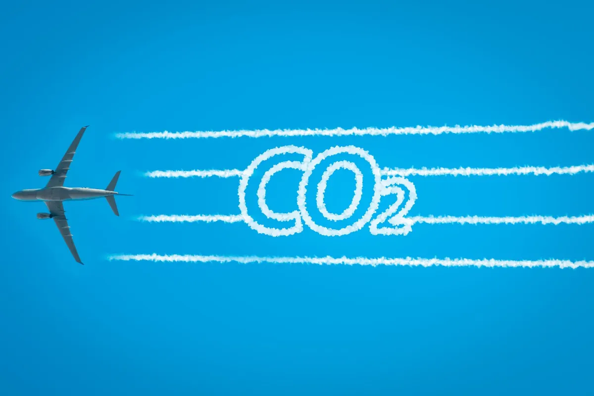 Airplane leaving jet contrails with CO2 word inside