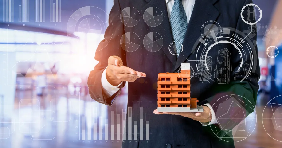 Businessman holding a miniature building while explaining